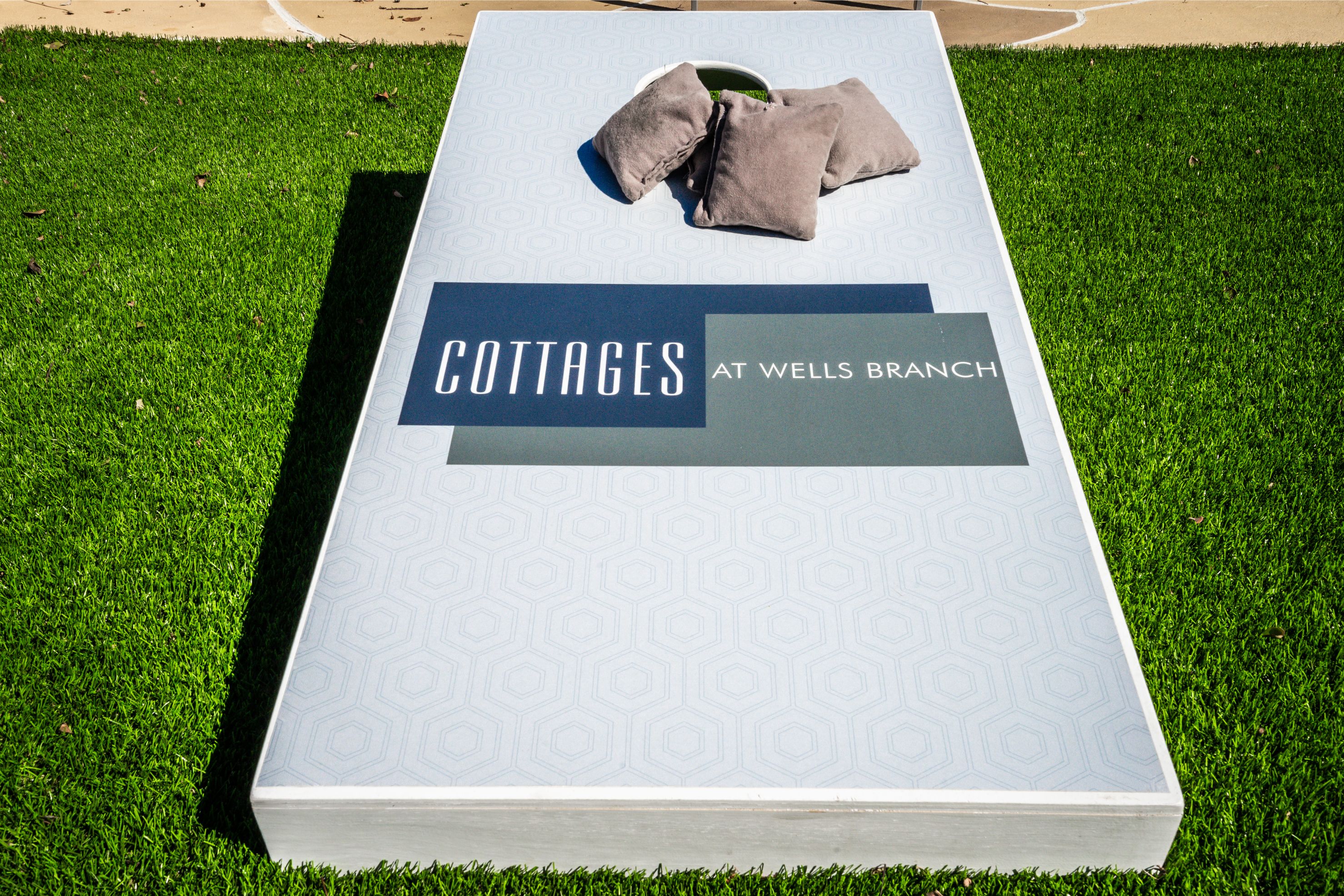 a mattress on the grass with clothes on top of it