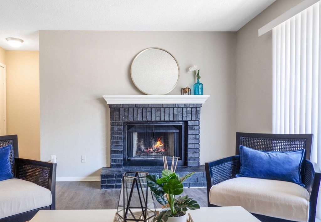1 Park Central Apartments, Peachtree Corners, Georgia a living room with a fireplace and chairs