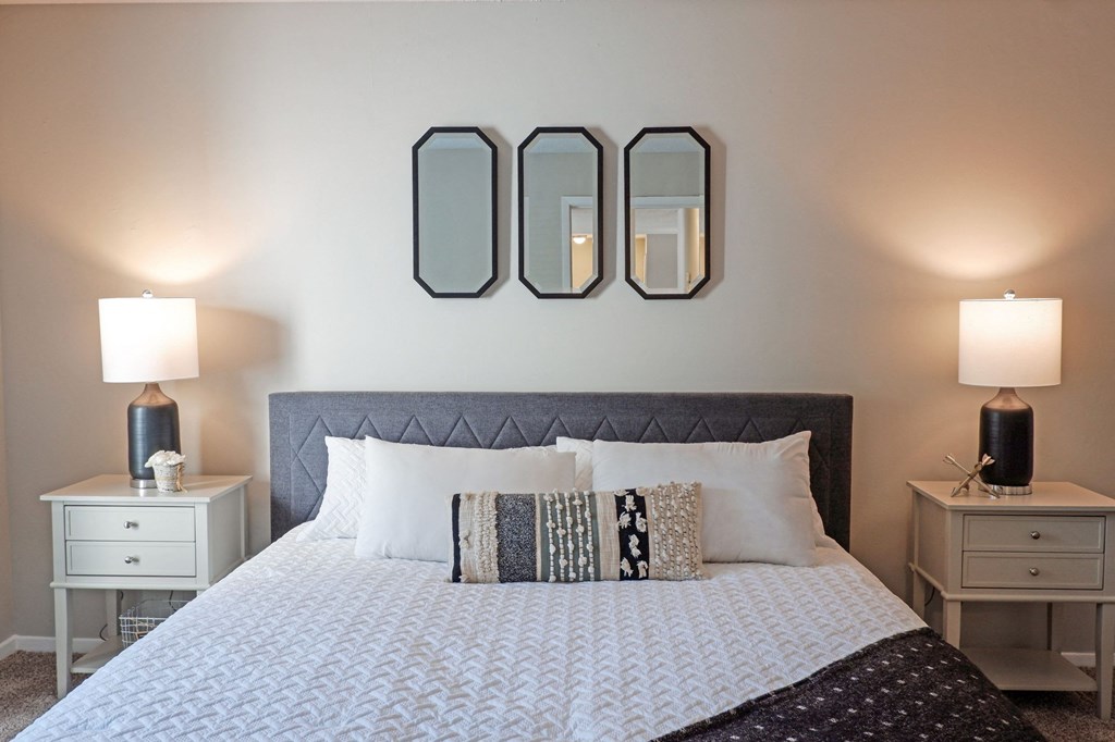 1 Park Central Apartments, Peachtree Corners, Georgia a bedroom with a bed and two night stands with lamps