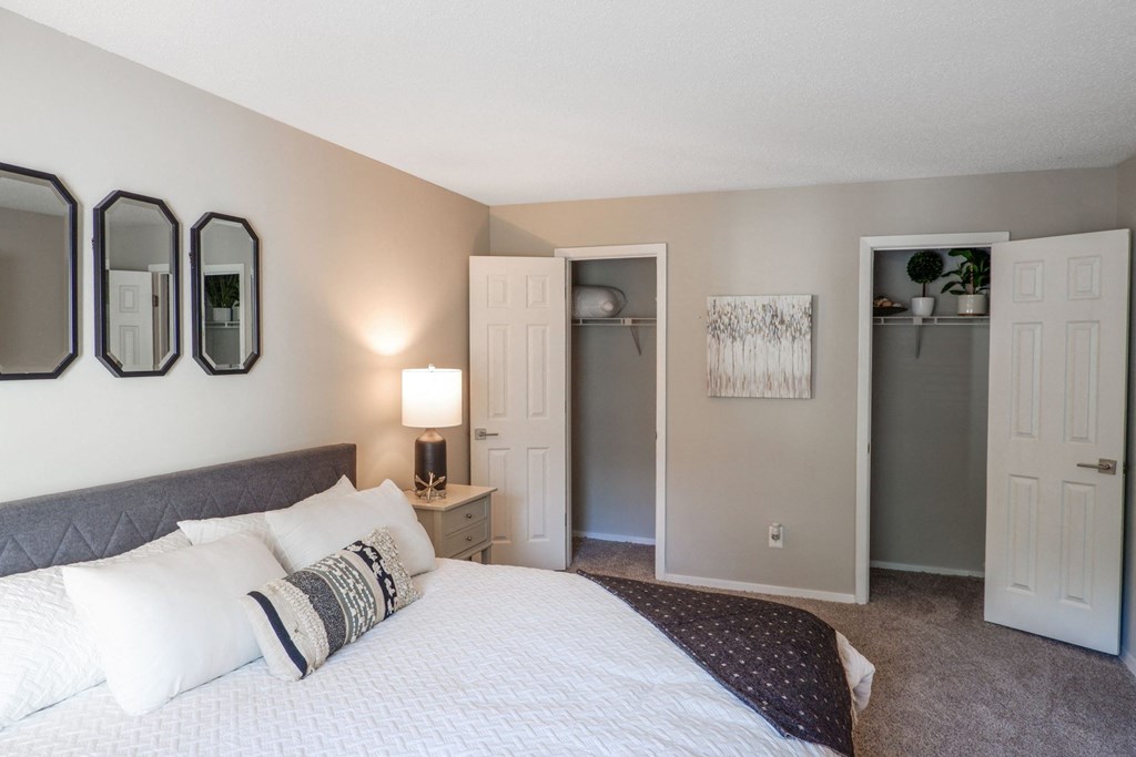 1 Park Central Apartments, Peachtree Corners, Georgia a bedroom with a large bed and two closets