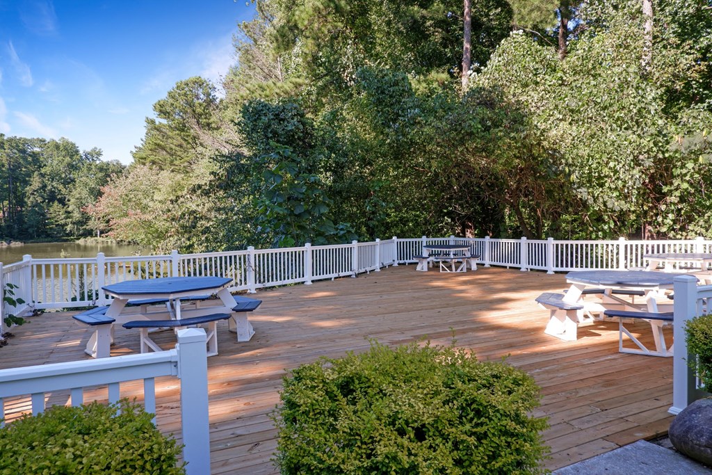 1 Park Central Apartments, Peachtree Corners, Georgia a large deck with picnic tables and a fence