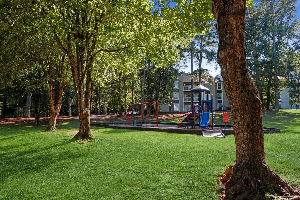 1 Park Central Apartments in Peachtree Corners photo of a park with a playground and buildings in the background