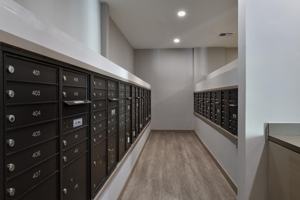 A hallway with black mailboxes numbered from 401 to 407.