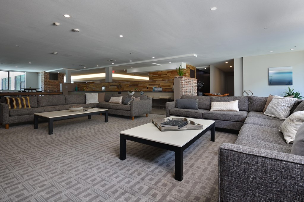 A living room with grey couches and a coffee table.