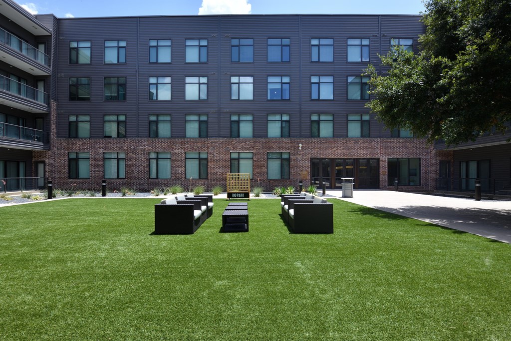 A modern building with a green lawn in front.