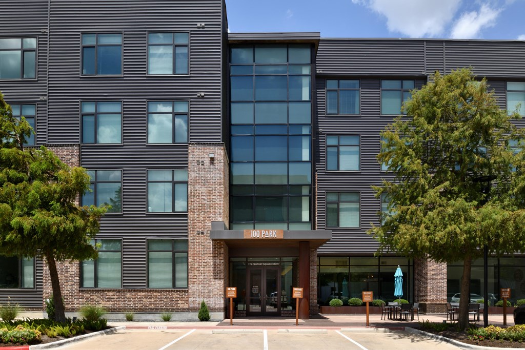 A modern building with a glass entrance and a brick facade.