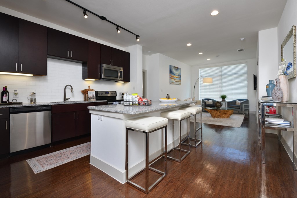 A kitchen with dark brown cabinets and white appliances.
