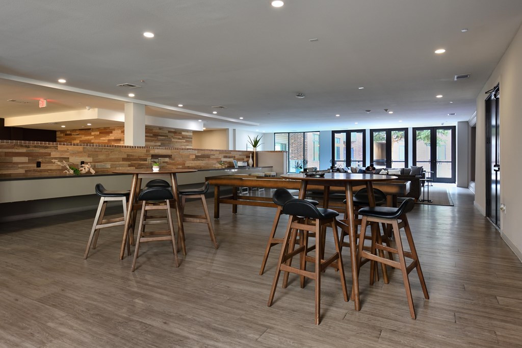 A dining area with a long table and chairs.