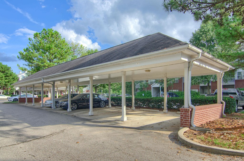Enclave at Wolfchase Apartments in Cordova Tennessee photo of a covered parking lot with cars parked under it