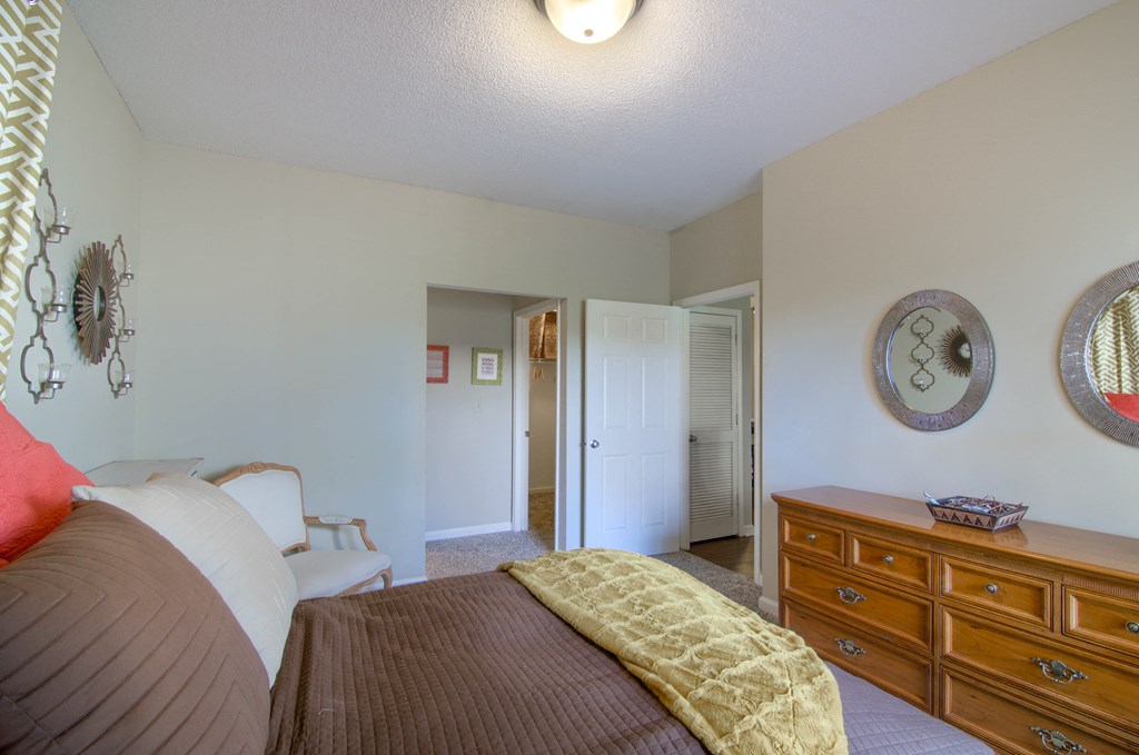 Enclave at Wolfchase Apartments in Cordova Tennessee photo of a bedroom with a bed and a dresser