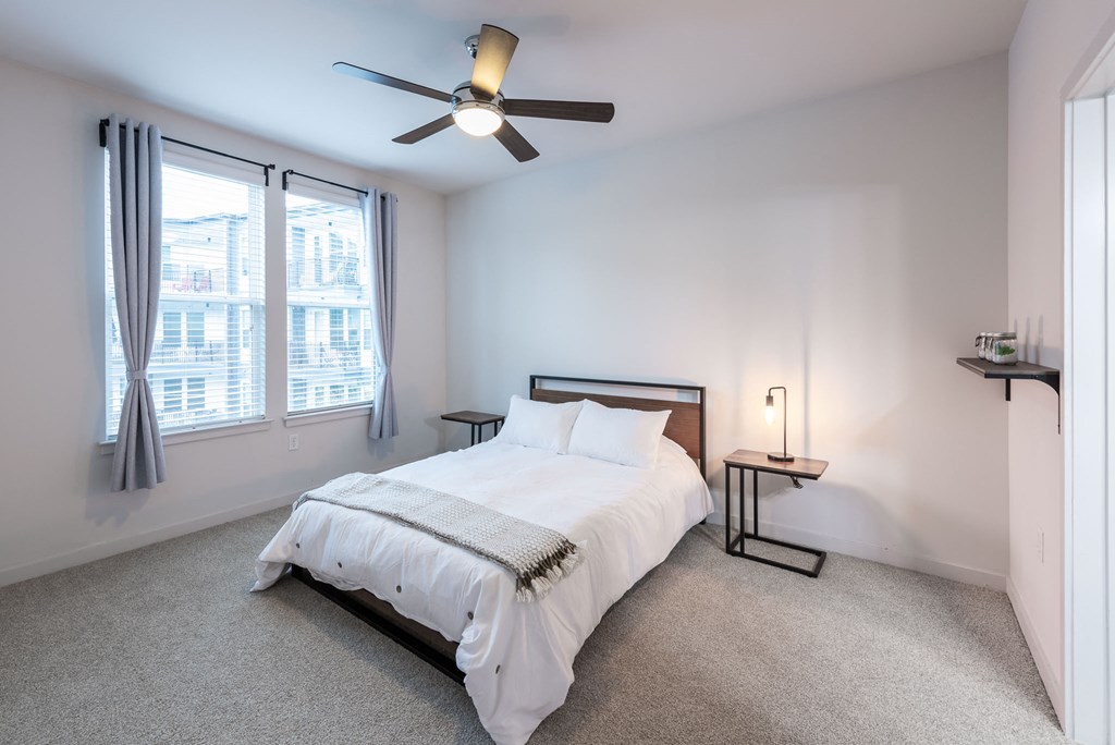 Station R Apartments in Atlanta GA photo of bedroom with large window and ceiling fan
