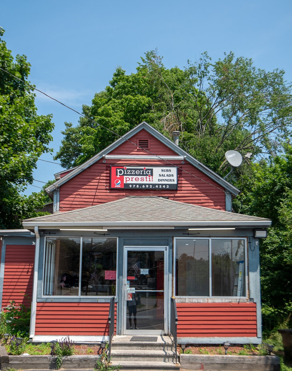 a red building with a sign on the front of it