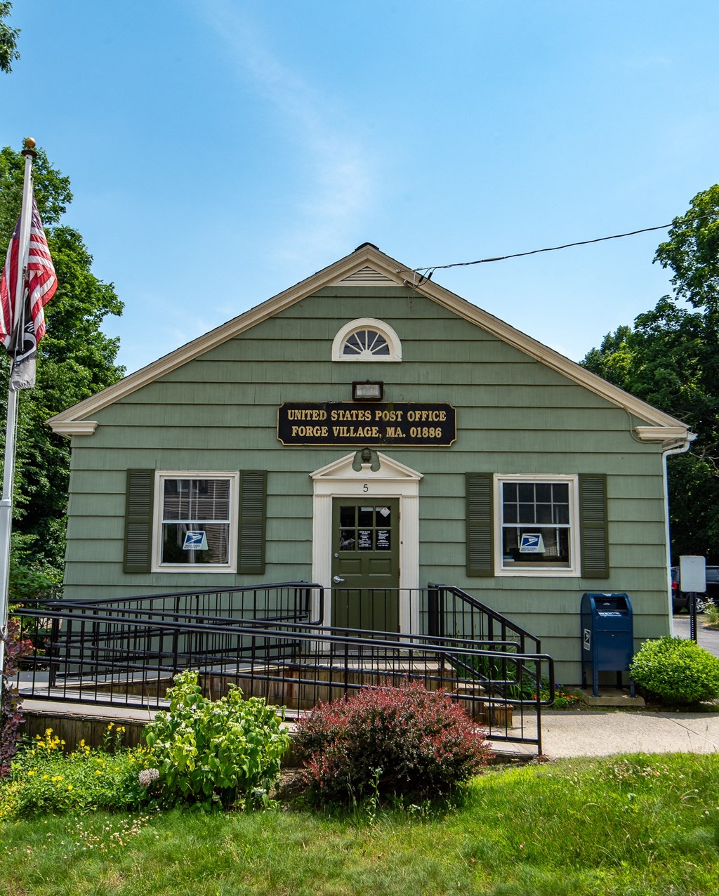 a green building with a sign on the front of it