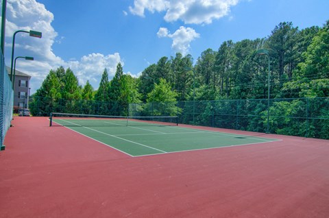 Lancaster Place Apartments in Calera Alabama photo of a tennis court with trees in the background
