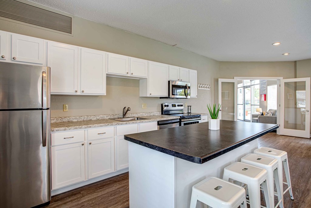 a kitchen with white cabinets and a counter top