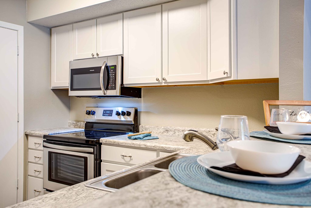 a kitchen with a sink and a microwave