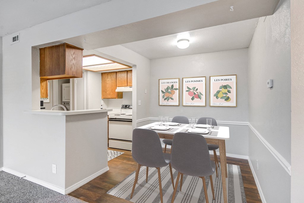 a dining room with a table and chairs and a kitchen