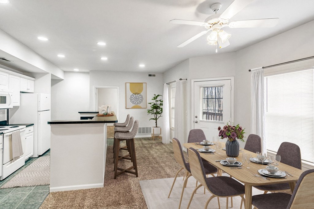 a dining room and kitchen with a table and chairs