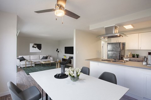 a kitchen and living room with a white table