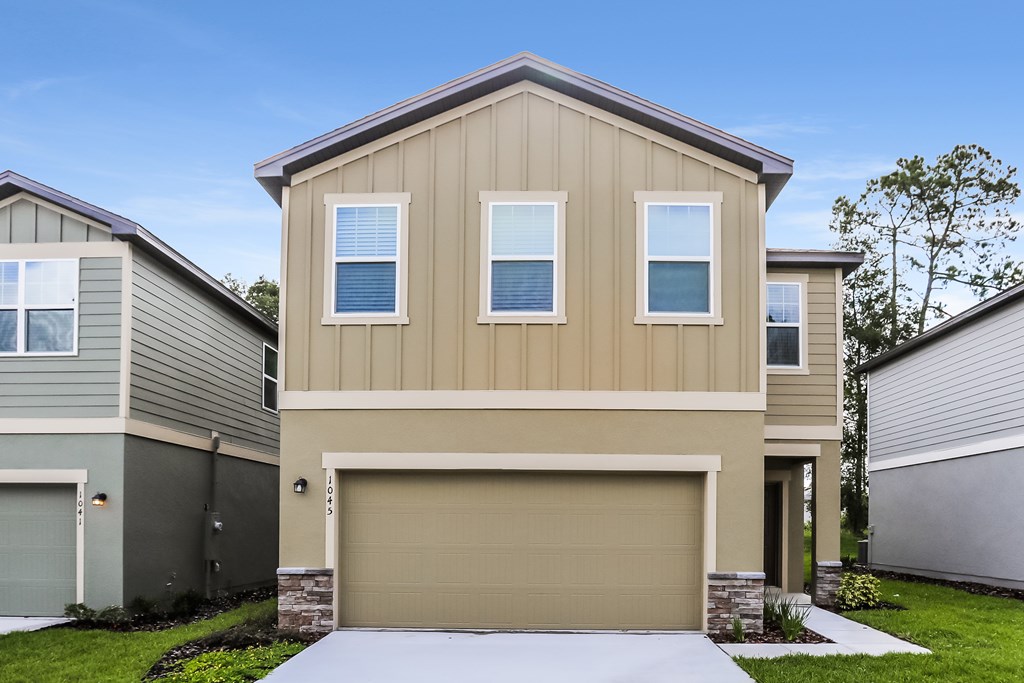 A modern house with a garage door in the front.