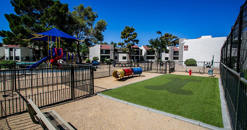 a playground in a fenced in area with a slide