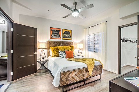 a bedroom with a bed and a ceiling fan