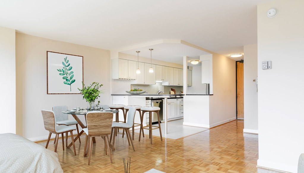 A dining room with a table set for six with a plant on the table.