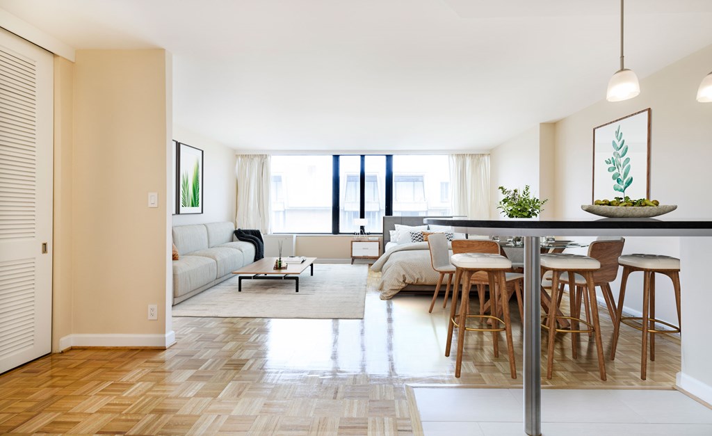 A modern living room with a dining area and a large window.