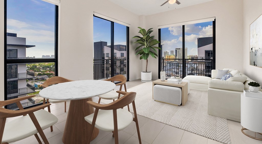 a living room with a couch and a table and a balcony