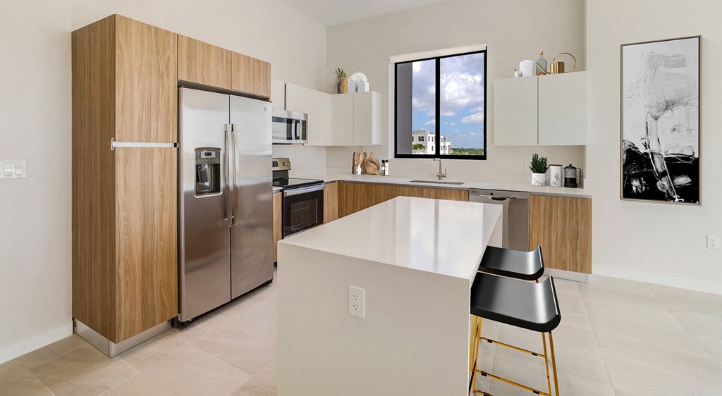 a modern kitchen with stainless steel appliances and a white counter top