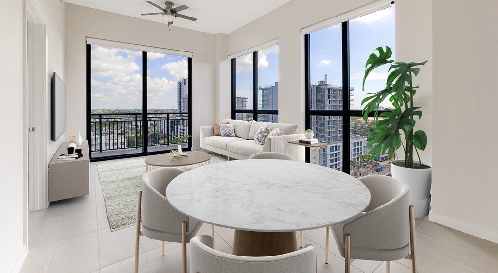 a living room with a couch and a table and a balcony