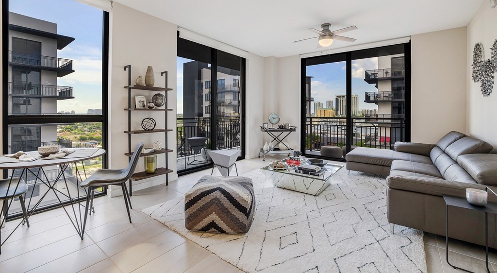 a living room with a couch and a table and a balcony
