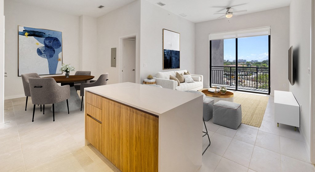 a kitchen island in a living room with a couch and a table