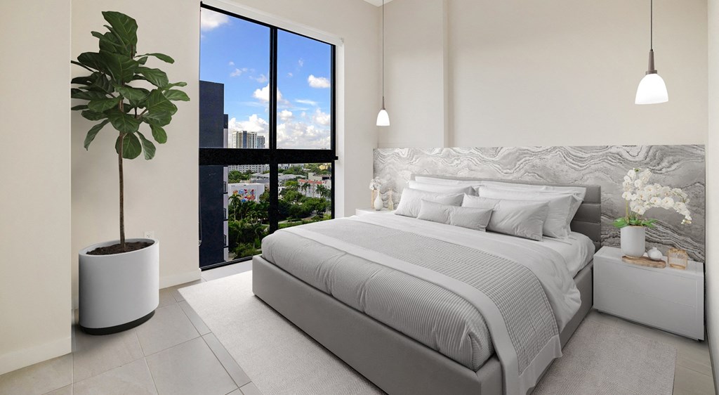 a white bedroom with a bed and a large window