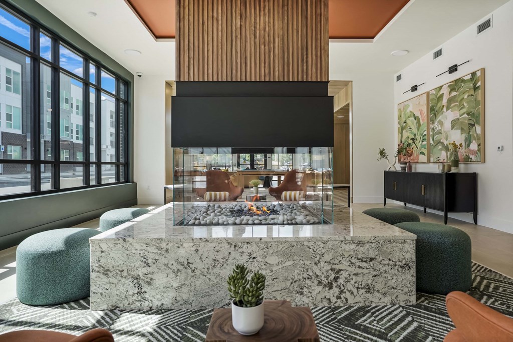 a living room with a marble table and a fireplace