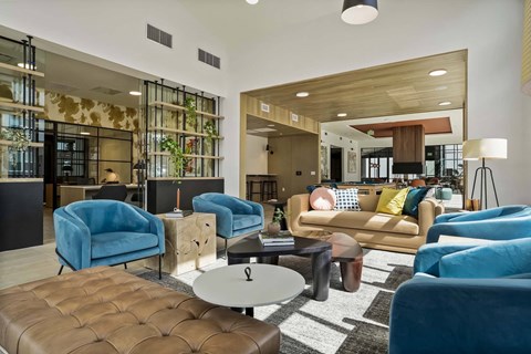 a living room with blue chairs and couches