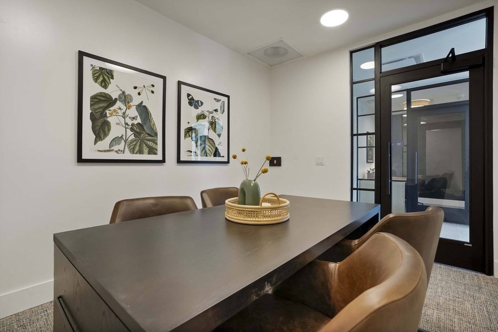 a dining room with a wooden table and chairs