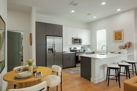 a kitchen and dining area with a table and chairs