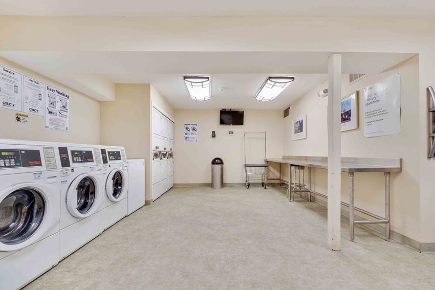 a spacious laundry room with washers and dryers