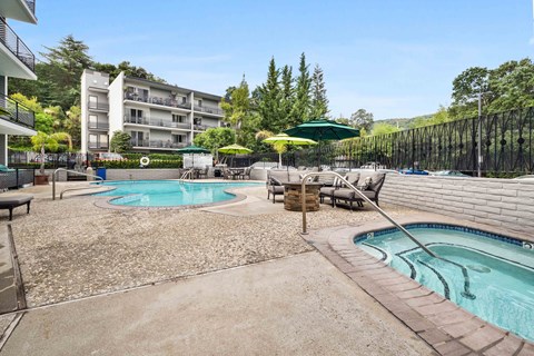 Apartment Los Gatos, CA - El Gato Penthouse - Resort Style Pool And Spa Courtyard With Lounge Seating, Umbrella Tables, Apartment Balconies, And Tree Lined Hills.