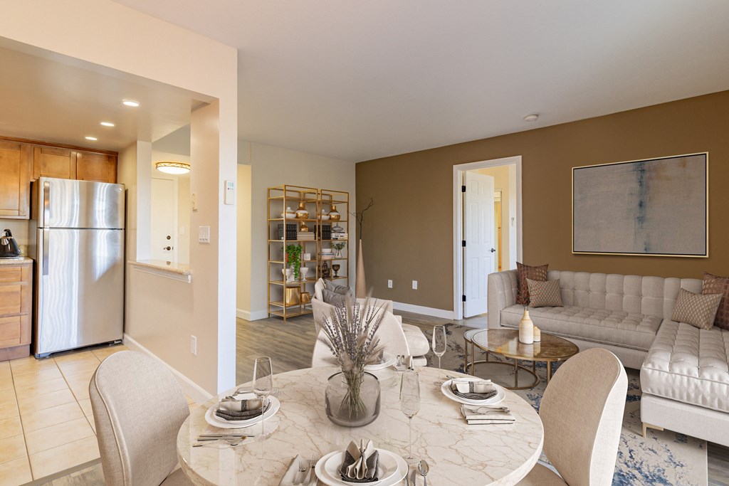 a living room and dining room with a white table and chairs