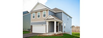 A two-story house with a garage on the first floor.