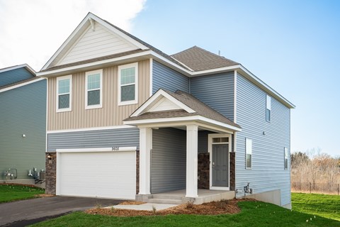 A two-story house with a garage on the first floor.