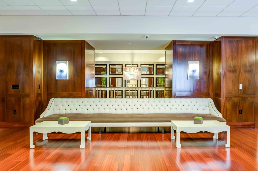 Long white leather sofa against wall in main entry lobby