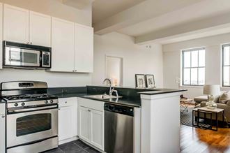 Kitchen with white cabinets and stainless appliances - Photo Gallery