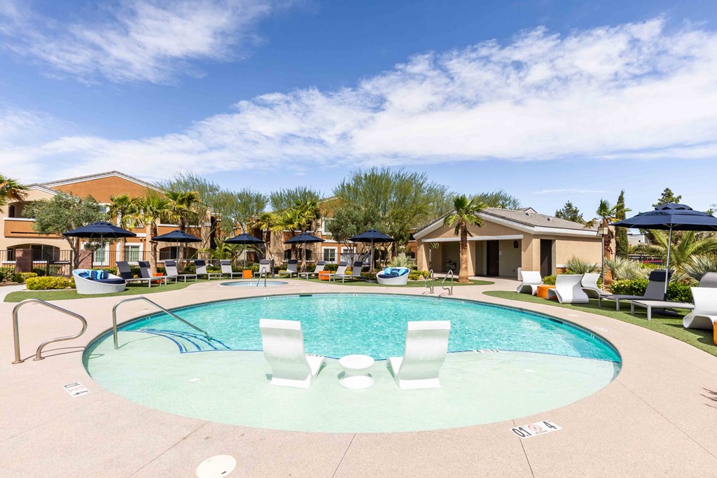 a swimming pool at a resort with umbrellas