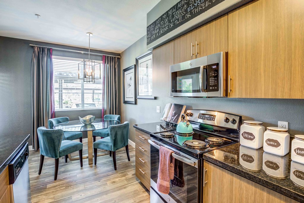 a kitchen with a stove and a table with chairs