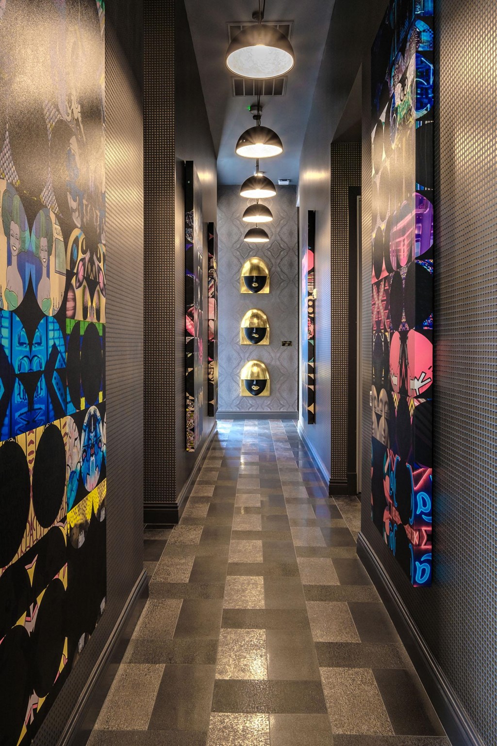 a hallway with a wall of comic panels and a corridor with a lighted hallway