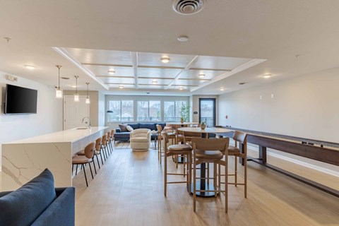 A modern living room with a long wooden table and chairs.