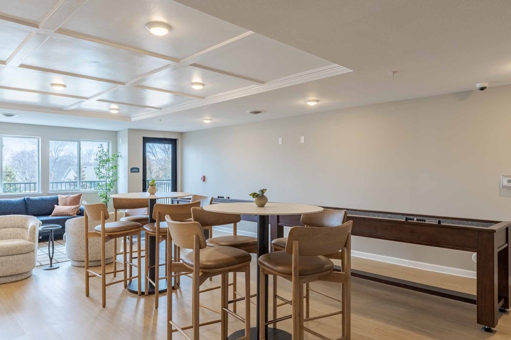 A modern kitchen with a dining table and chairs.